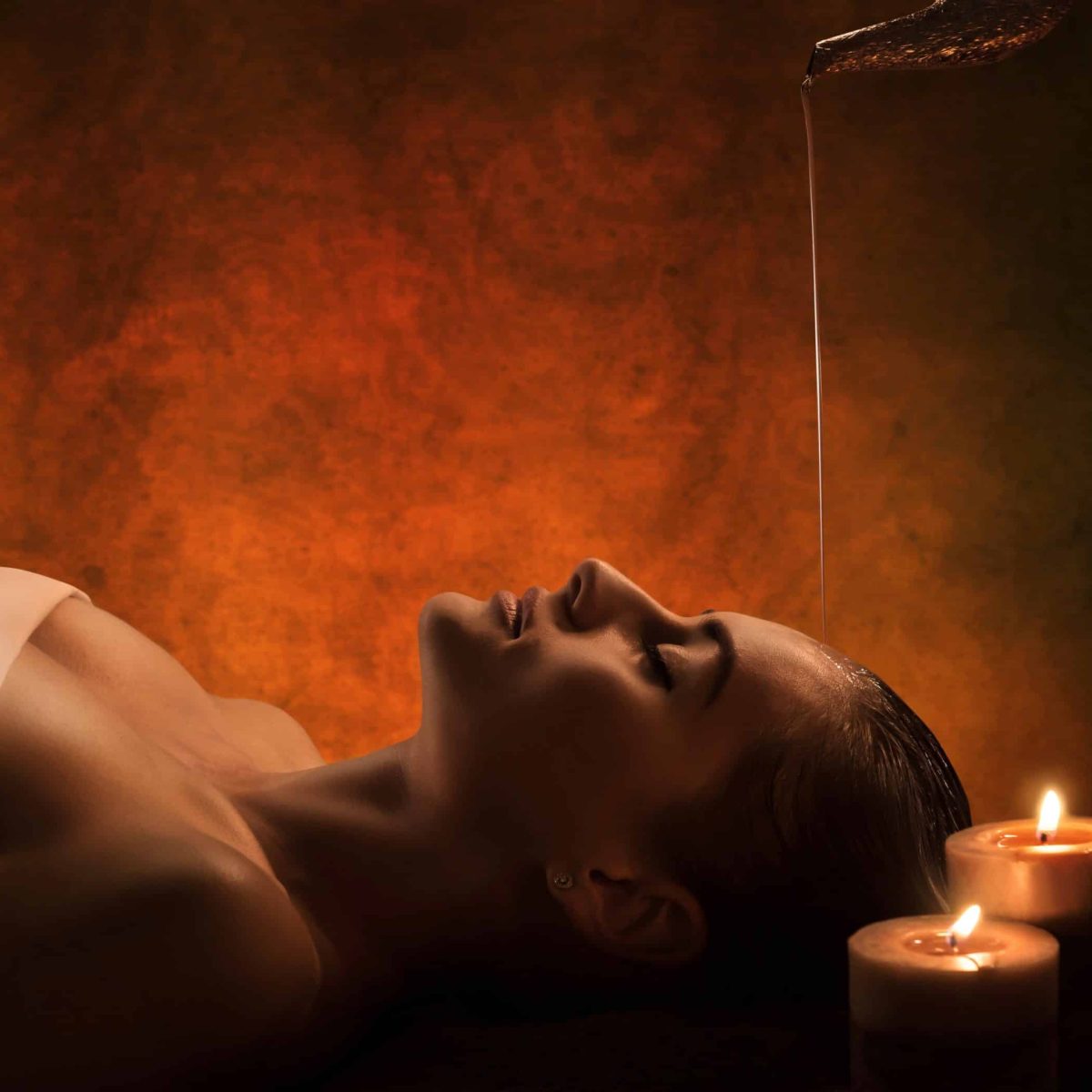 The girl has Shirodhara treatment - indian oil massage.